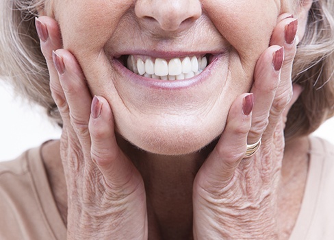 Older woman showing off flawless smile