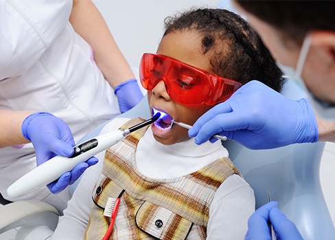 Child receiving dental sealants