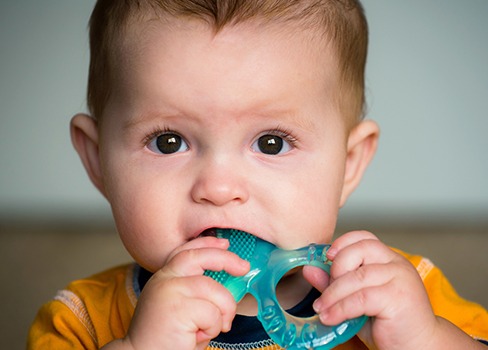 Child biting down on teething ring