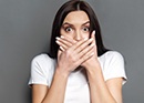 Woman covering mouth