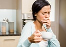 Woman in pain covering mouth