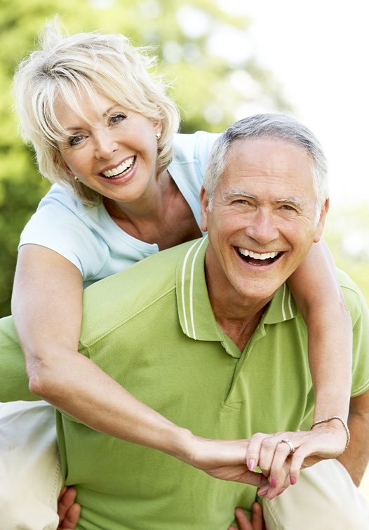 Older man and woman smiling outdoors