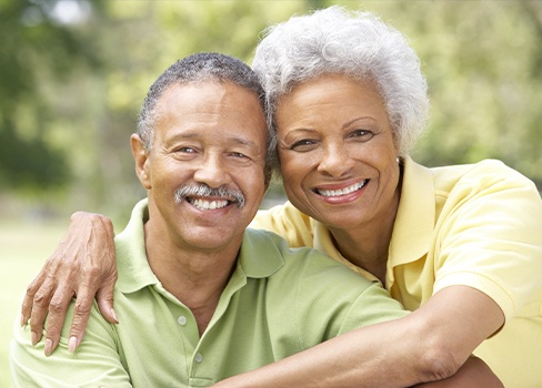 Older man and woman outdoors smiling