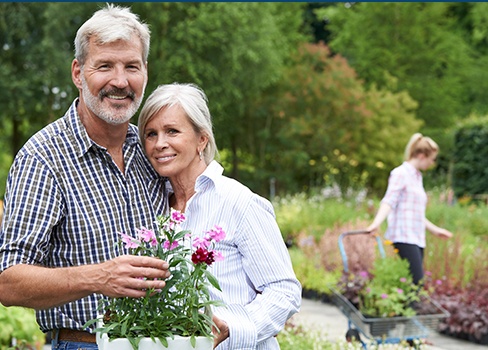 Older man and woman smiling together outdoors