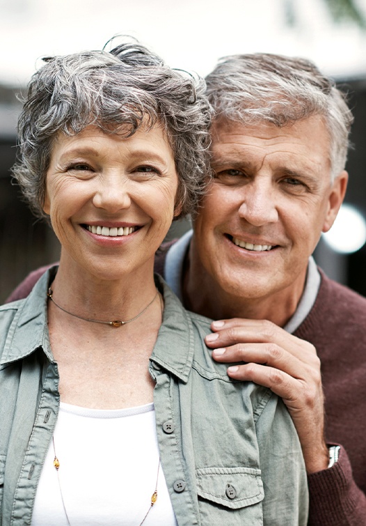 Older man and woman smiling outdoors