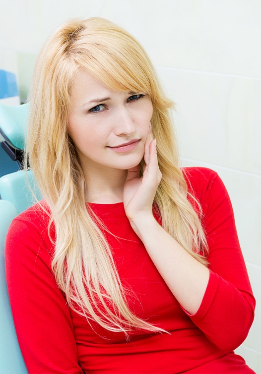 Woman in pain holding jaw