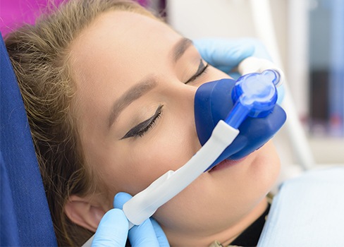 Woman with nitrous oxide nose mask