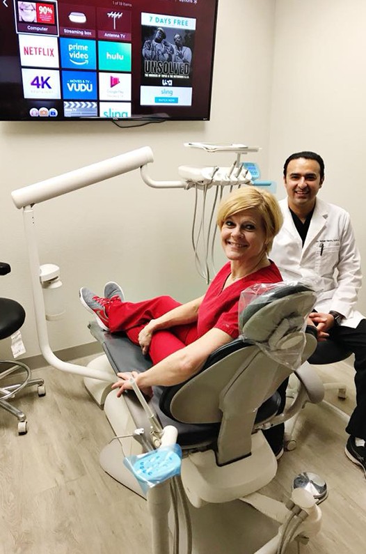 Dr. Kazmi and young patient in dental exam room