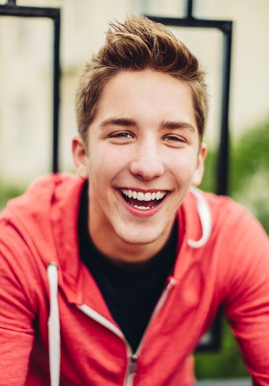 Young man outdoors smiling